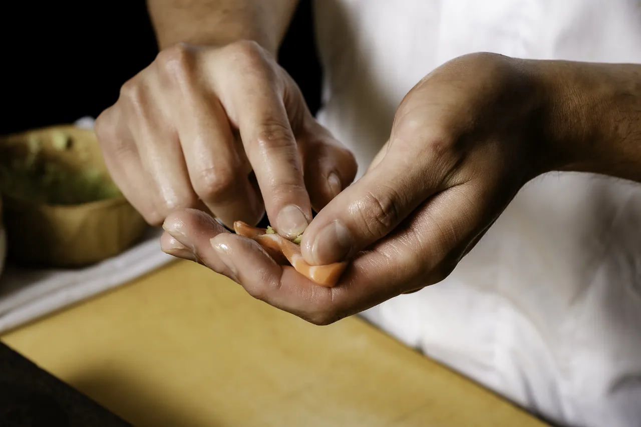A chef shaping nigiri by hand